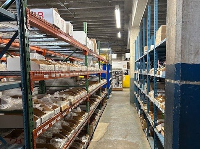 Shelves stocked with plumbing supplies in the Hughes Supply Salisbury warehouse