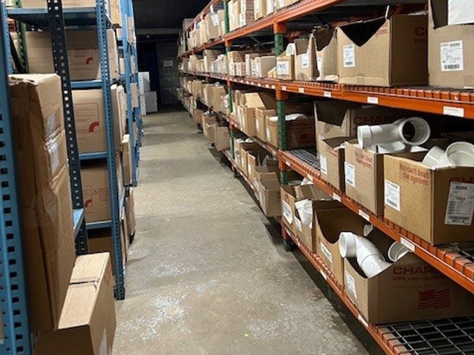 Warehouse shelves stocked with plumbing supplies at Hughes Supply Salisbury