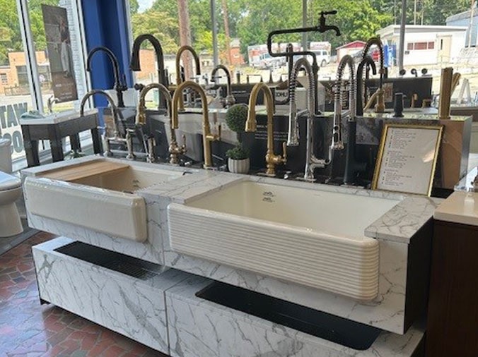 Multiple variations of kitchen sink faucets in the Hughes Supply Salisbury showroom