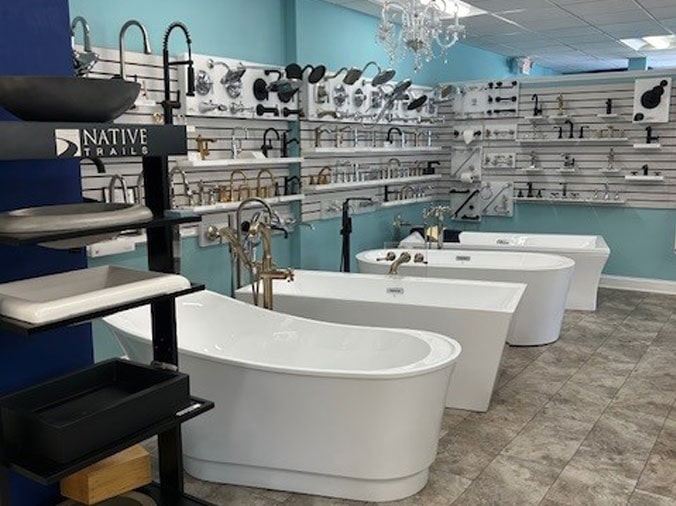 Free standing bathtubs and shower heads on display in the Hughes Supply Salisbury showroom