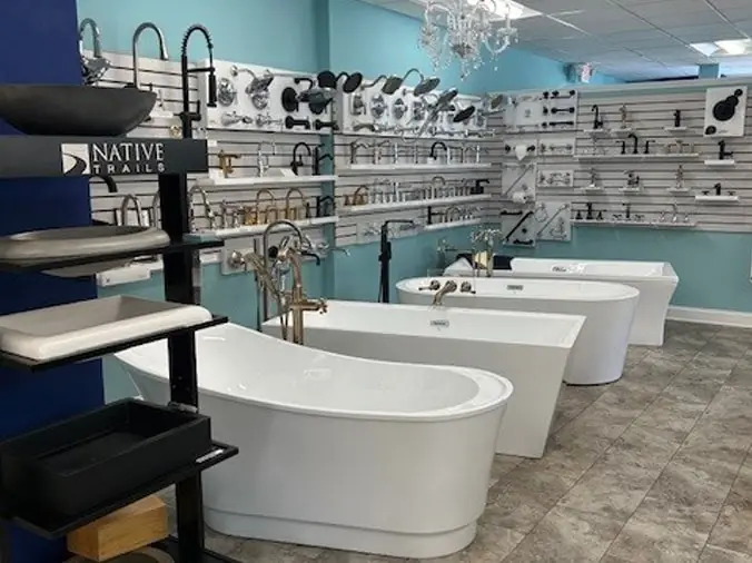 Free standing bathtubs and shower heads on display in the Hughes Supply Salisbury showroom